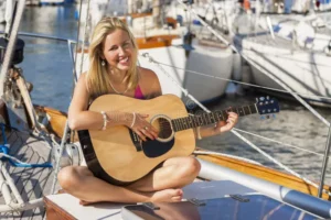 local girl playing a solo guitar on Belgrade River Cruise boat