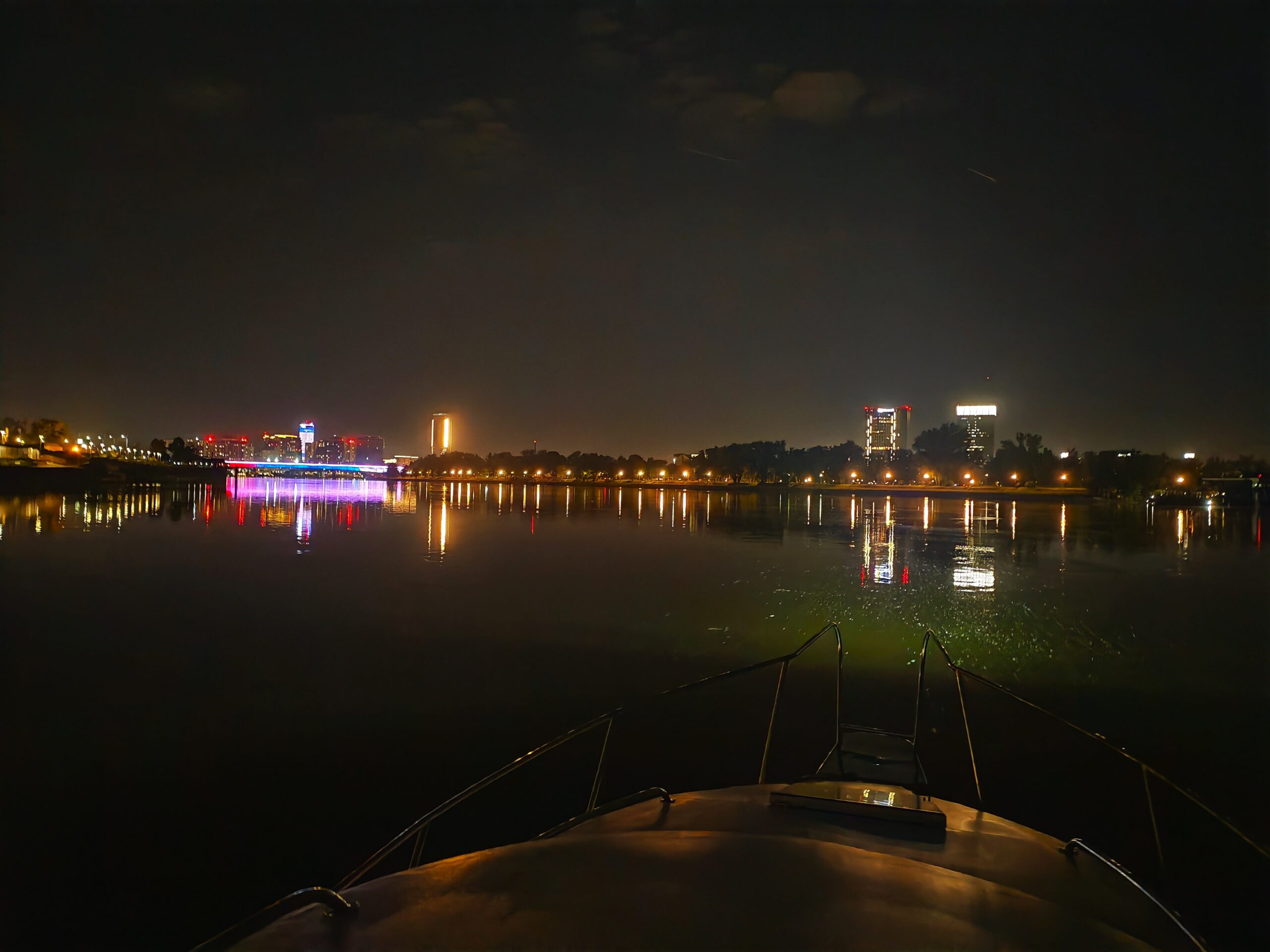 Illuminated Belgrade bridges and city skyline viewed from the bow of a BELGRADE RIVER CRUISE boat during a 1-hour night cruise